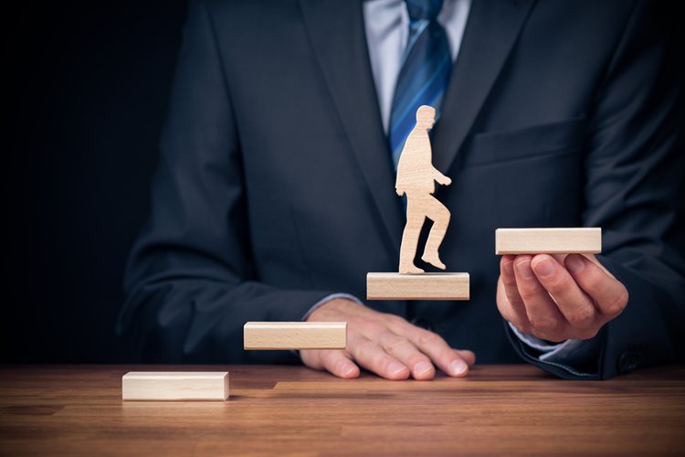 mini wooden figure climbing stairs