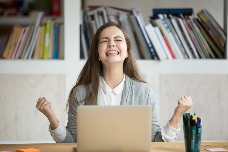 young woman cheering in office