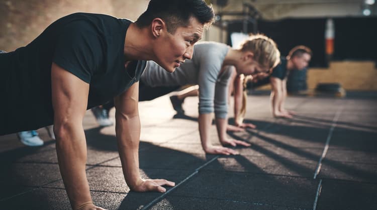 people doing push ups at the gym