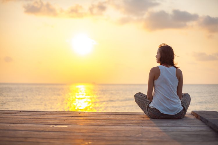 young woman doing yoga outside