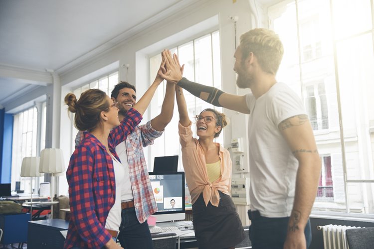 young colleagues high fiving