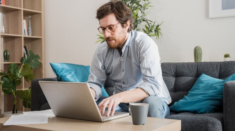 man working on laptop from home