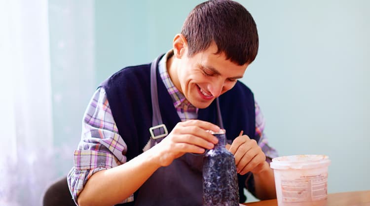 man with disability participating in arts and craft activity