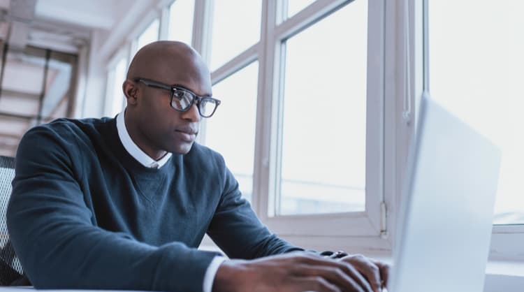 man looking at laptop screen intently