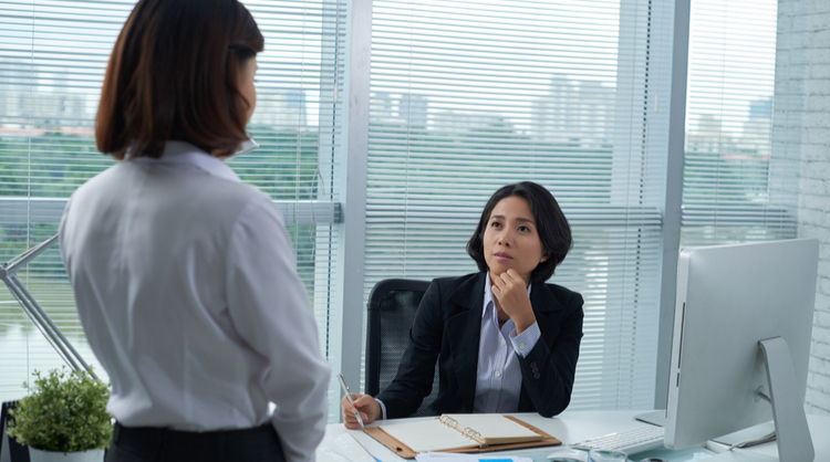 asian woman boss talking with colleague